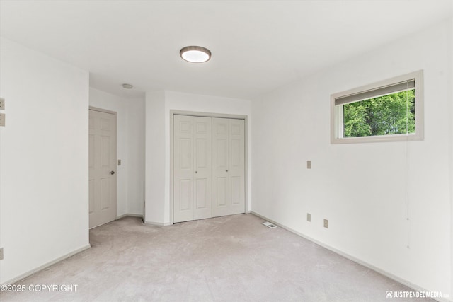 1701 Woo Blvd, Anchorage, AK 99515 - unfurnished bedroom with light colored carpet, a closet, and baseboards
