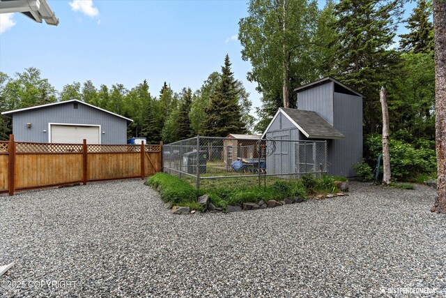 1701 Woo Blvd, Anchorage, AK 99515 - view of yard featuring a detached garage and an outbuilding