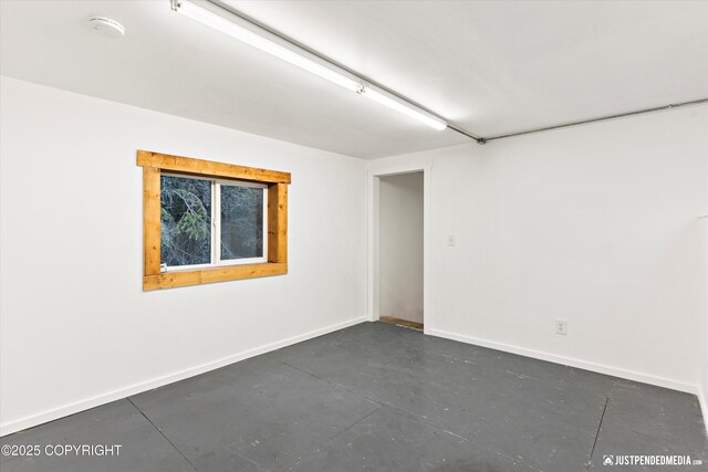 1701 Woo Blvd, Anchorage, AK 99515 - empty room featuring finished concrete floors, baseboards, and a smoke detector