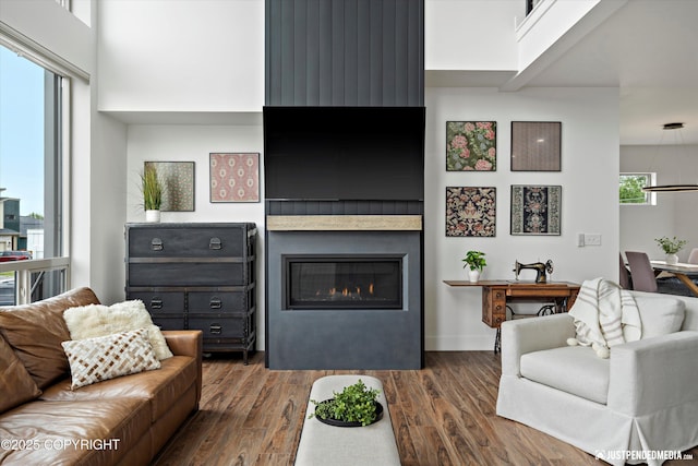 7864 Crane Cir, Anchorage, AK 99502 - living room featuring dark wood-style floors and a large fireplace