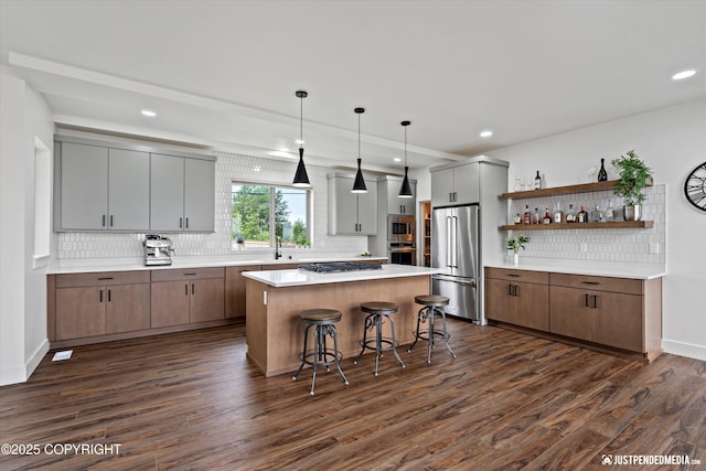 7864 Crane Cir, Anchorage, AK 99502 - kitchen featuring stainless steel appliances, backsplash, dark wood-type flooring, open shelves, and a center island