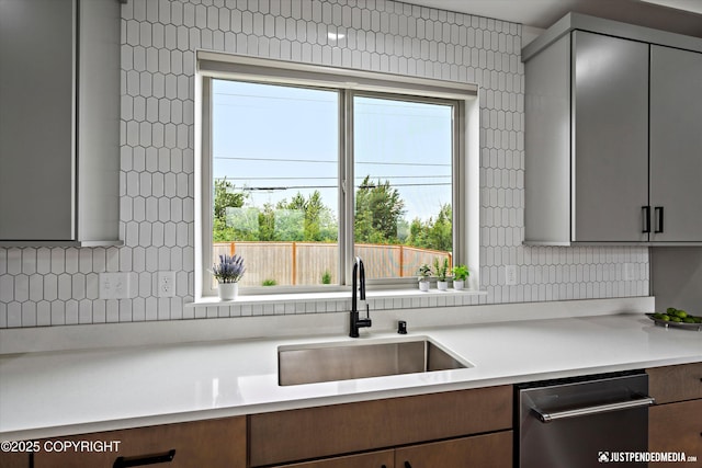 7864 Crane Cir, Anchorage, AK 99502 - kitchen featuring stainless steel dishwasher, plenty of natural light, and light countertops