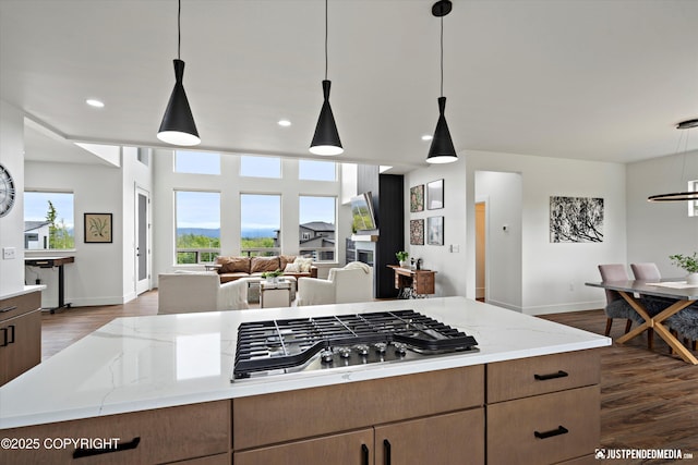 7864 Crane Cir, Anchorage, AK 99502 - kitchen featuring stainless steel gas cooktop, dark wood-type flooring, light stone counters, open floor plan, and recessed lighting