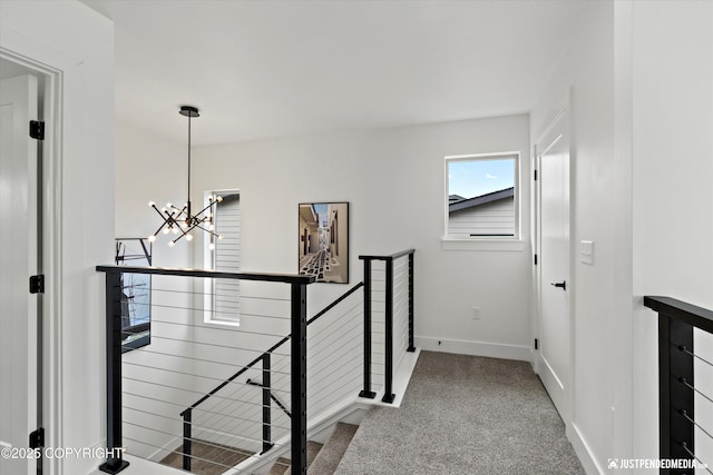 7864 Crane Cir, Anchorage, AK 99502 - hallway with an upstairs landing, a chandelier, and carpet