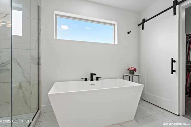 7864 Crane Cir, Anchorage, AK 99502 - bathroom featuring marble look tiles, a spacious closet, a freestanding bath, and a marble finish shower