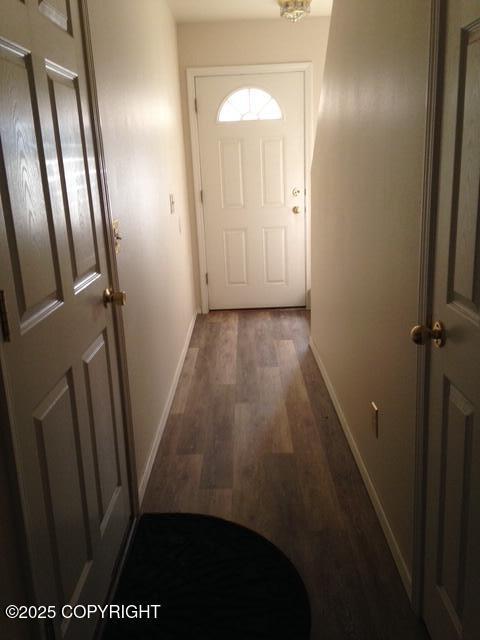 17491 Fire Eagle Way # 6, Eagle River, AK 99577 - doorway with dark wood finished floors and baseboards