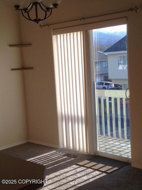 17491 Fire Eagle Way # 6, Eagle River, AK 99577 - spare room featuring a chandelier and carpet floors