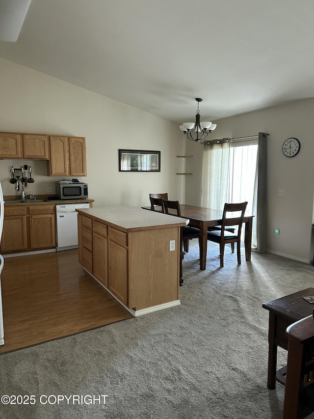17491 Fire Eagle Way # 6, Eagle River, AK 99577 - kitchen featuring white dishwasher, stainless steel microwave, a chandelier, carpet, and lofted ceiling