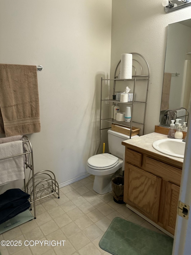 17491 Fire Eagle Way # 6, Eagle River, AK 99577 - bathroom with vanity, toilet, and baseboards