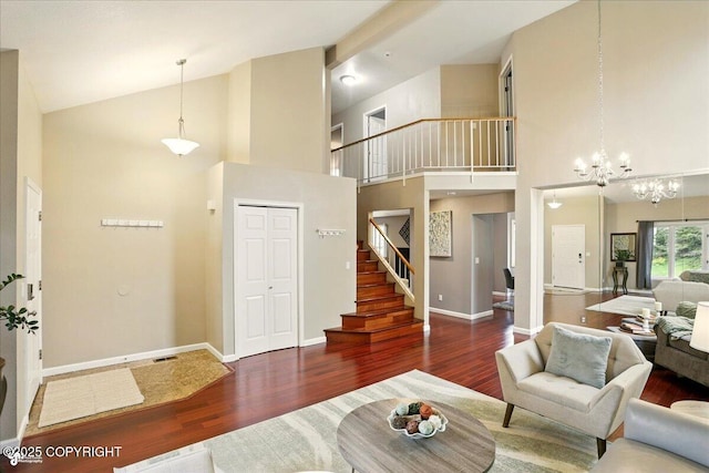 2350 Ariel Cir, Anchorage, AK 99515 - living area featuring stairway, wood finished floors, high vaulted ceiling, a chandelier, and baseboards