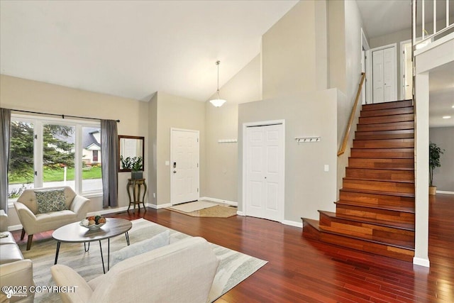 2350 Ariel Cir, Anchorage, AK 99515 - living room featuring wood finished floors, stairs, baseboards, and high vaulted ceiling