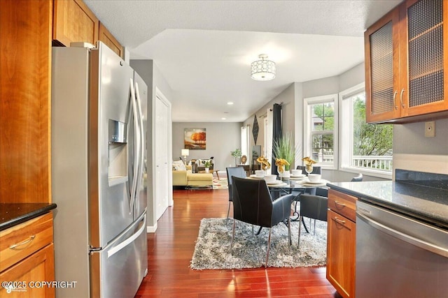 2350 Ariel Cir, Anchorage, AK 99515 - kitchen with stainless steel appliances, dark wood-style floors, brown cabinetry, glass insert cabinets, and open floor plan