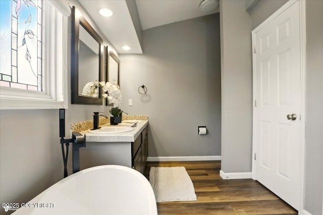 2350 Ariel Cir, Anchorage, AK 99515 - bathroom with a freestanding bath, vanity, recessed lighting, wood finished floors, and baseboards