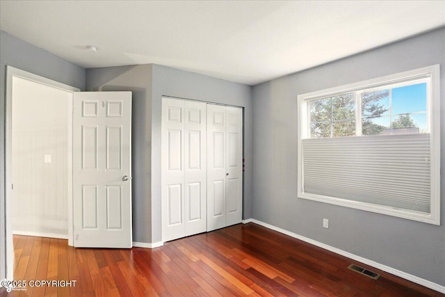 2350 Ariel Cir, Anchorage, AK 99515 - unfurnished bedroom with dark wood-style flooring, baseboards, and a closet