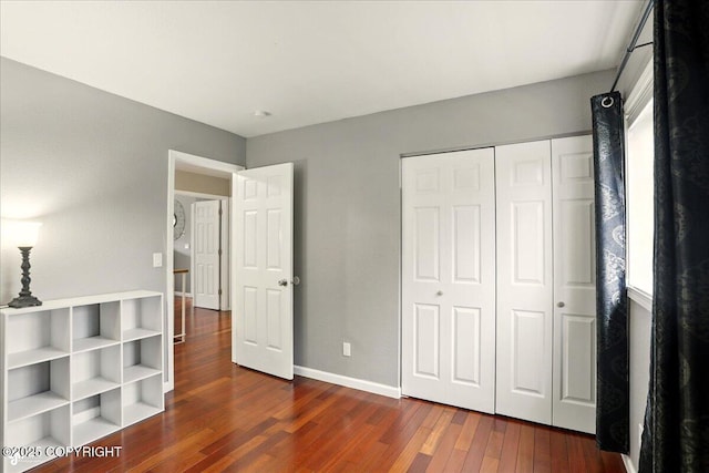 2350 Ariel Cir, Anchorage, AK 99515 - unfurnished bedroom with dark wood-type flooring, a closet, and baseboards