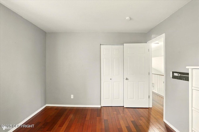 2350 Ariel Cir, Anchorage, AK 99515 - unfurnished bedroom with hardwood / wood-style flooring, baseboards, and a closet