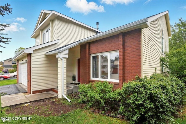 2350 Ariel Cir, Anchorage, AK 99515 - view of side of property with brick siding and driveway