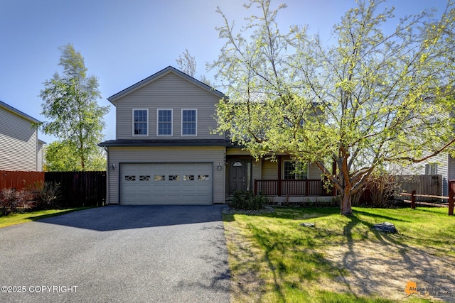 5893 Kenai Fjords Loop, Anchorage, AK 99502 - traditional home with asphalt driveway, an attached garage, and a porch