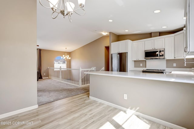 5893 Kenai Fjords Loop, Anchorage, AK 99502 - kitchen featuring appliances with stainless steel finishes, a chandelier, white cabinetry, light countertops, and recessed lighting