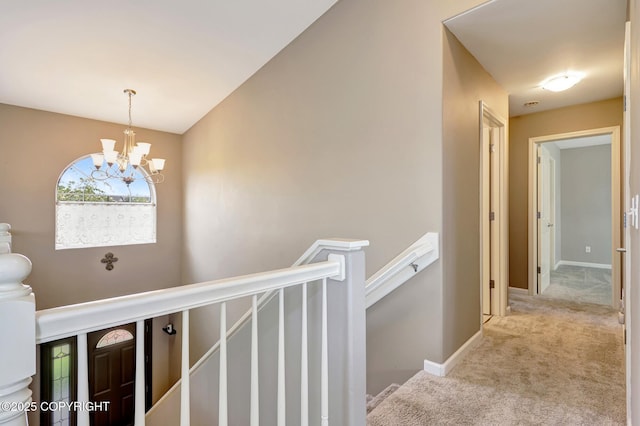 5893 Kenai Fjords Loop, Anchorage, AK 99502 - hall featuring an upstairs landing, carpet floors, a chandelier, and baseboards
