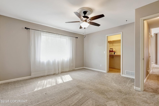 5893 Kenai Fjords Loop, Anchorage, AK 99502 - unfurnished bedroom with carpet floors, a spacious closet, baseboards, and a closet