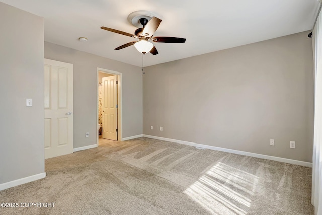 5893 Kenai Fjords Loop, Anchorage, AK 99502 - unfurnished bedroom featuring light colored carpet, baseboards, ceiling fan, and ensuite bathroom