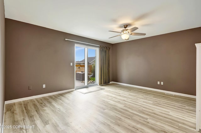 5893 Kenai Fjords Loop, Anchorage, AK 99502 - empty room featuring a ceiling fan, baseboards, and wood finished floors