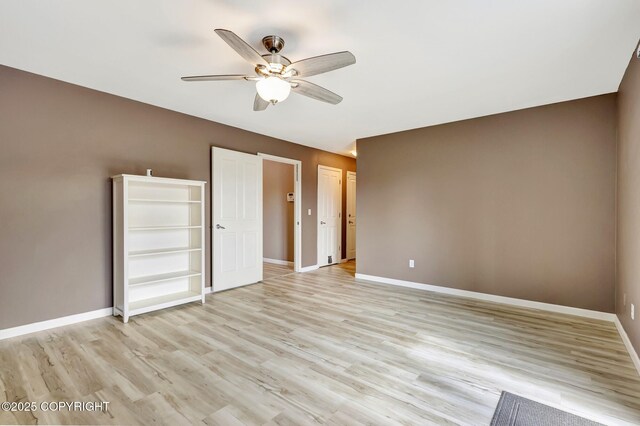 5893 Kenai Fjords Loop, Anchorage, AK 99502 - unfurnished bedroom featuring baseboards, light wood-style flooring, and ceiling fan
