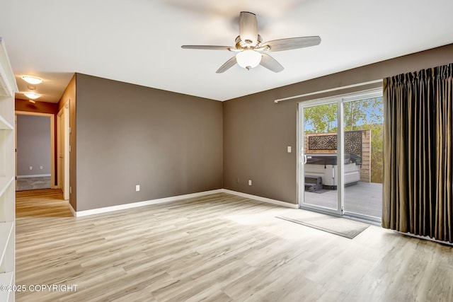 5893 Kenai Fjords Loop, Anchorage, AK 99502 - unfurnished room featuring a ceiling fan, light wood-type flooring, and baseboards