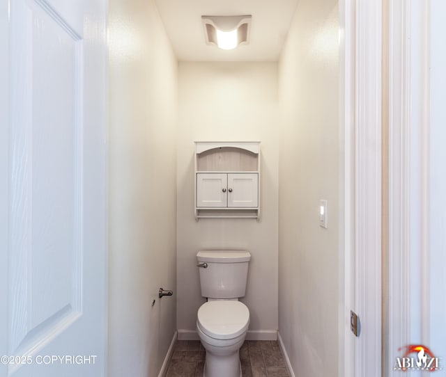 4106 E Country Fair Dr # A, Wasilla, AK 99654 - bathroom featuring toilet, baseboards, and tile patterned flooring