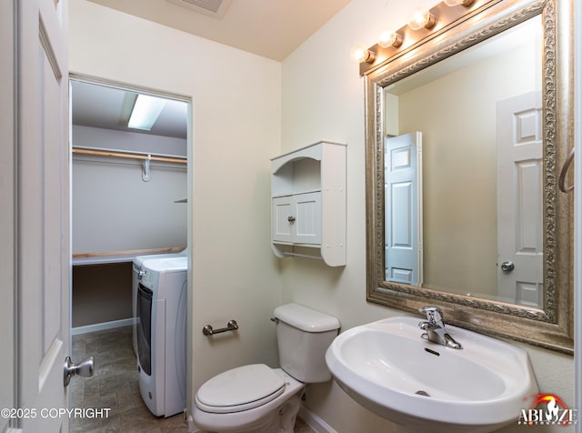 4106 E Country Fair Dr # A, Wasilla, AK 99654 - bathroom featuring washer / dryer, a sink, baseboards, and toilet