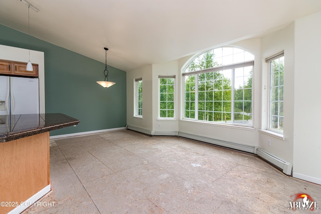 4106 E Country Fair Dr # A, Wasilla, AK 99654 - unfurnished dining area featuring vaulted ceiling, healthy amount of natural light, and baseboards