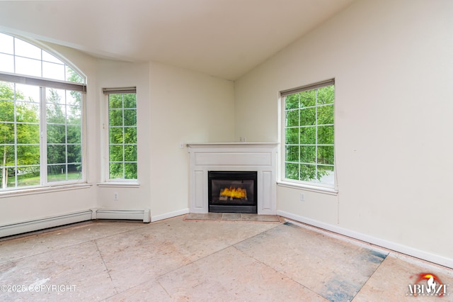 4106 E Country Fair Dr # A, Wasilla, AK 99654 - unfurnished living room with healthy amount of natural light, a glass covered fireplace, baseboards, and vaulted ceiling