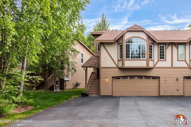 4106 E Country Fair Dr # A, Wasilla, AK 99654 - view of front of house with stairway, an attached garage, a shingled roof, and driveway