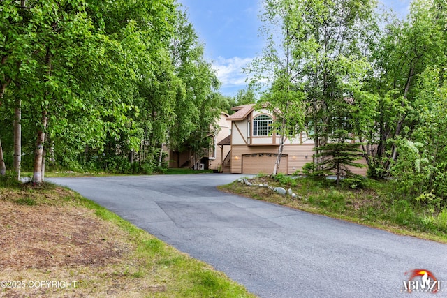 4106 E Country Fair Dr # A, Wasilla, AK 99654 - view of front of home with asphalt driveway, a garage, and stairway