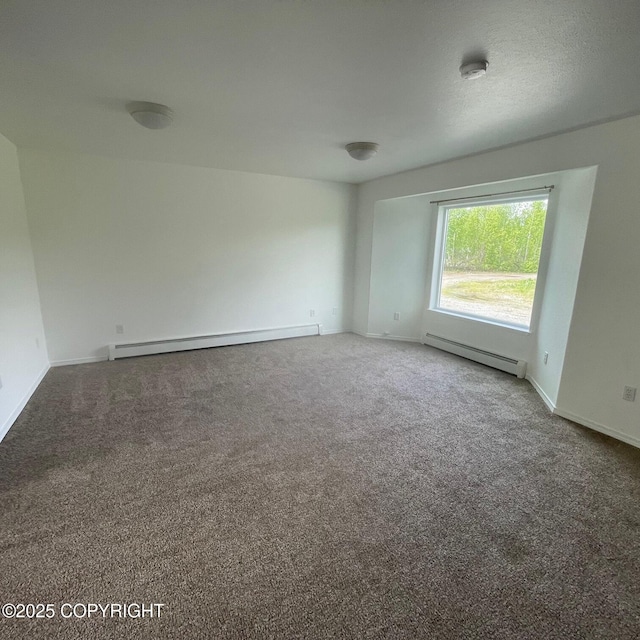14154 Jojoba Dr, Wasilla, AK 99654 - carpeted spare room with a baseboard radiator and baseboards