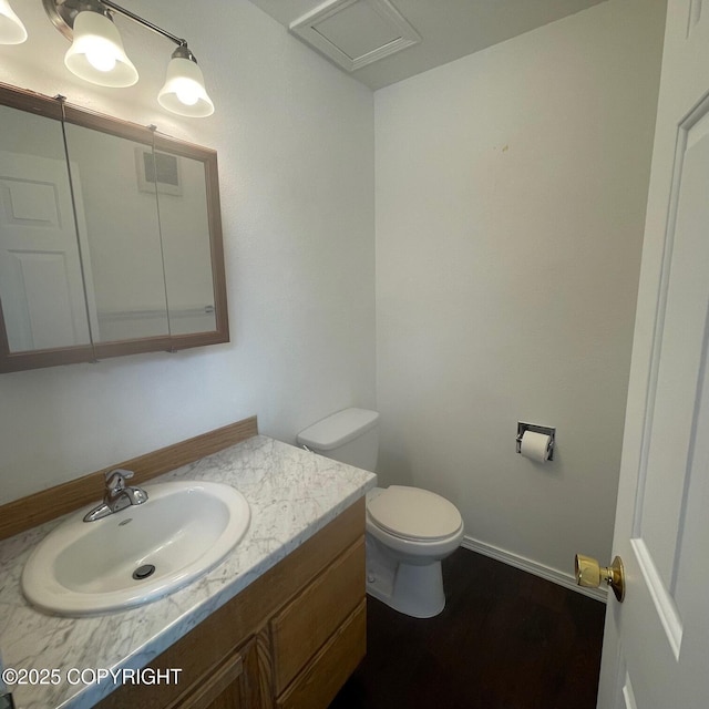 14154 Jojoba Dr, Wasilla, AK 99654 - bathroom featuring toilet, vanity, wood finished floors, and baseboards