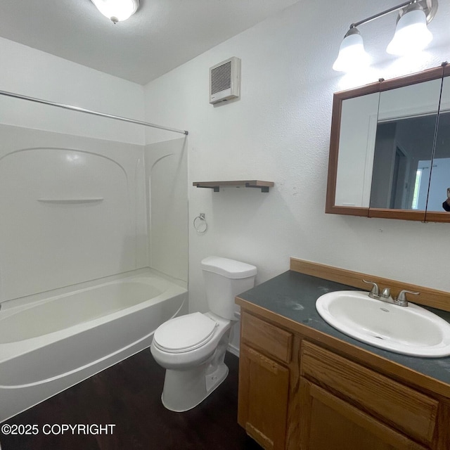 14154 Jojoba Dr, Wasilla, AK 99654 - full bathroom featuring vanity, toilet,  shower combination, and wood finished floors