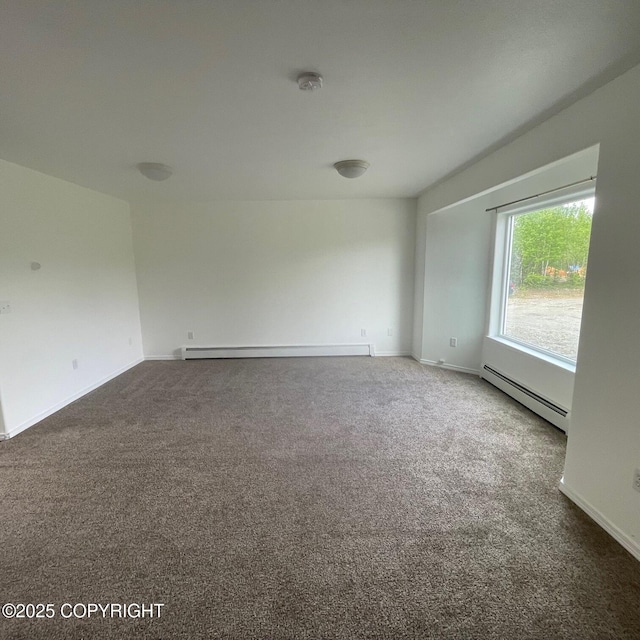 14154 Jojoba Dr, Wasilla, AK 99654 - empty room featuring a baseboard radiator, carpet flooring, baseboard heating, and a smoke detector