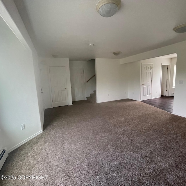 14154 Jojoba Dr, Wasilla, AK 99654 - unfurnished living room with dark colored carpet, baseboards, and stairway