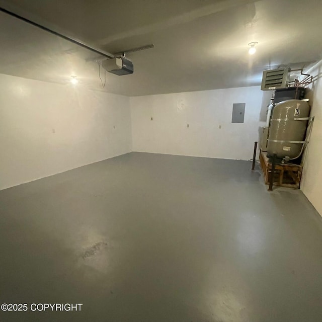 14154 Jojoba Dr, Wasilla, AK 99654 - garage with electric panel, a garage door opener, and a central vacuum unit