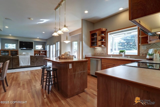 16059 Hidden Creek Ln, Anchorage, AK 99516 - kitchen with open shelves, stainless steel dishwasher, a sink, light wood-style floors, and a kitchen island