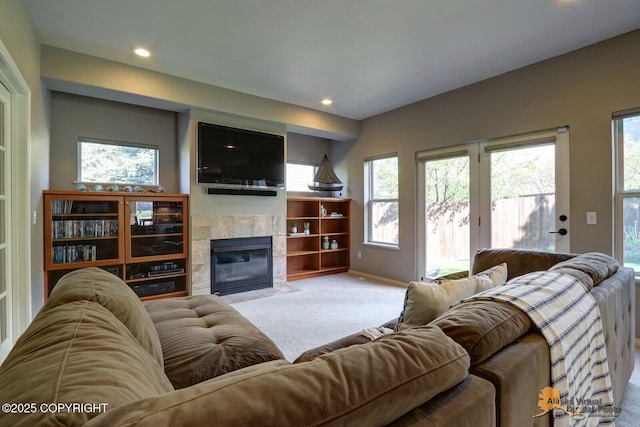16059 Hidden Creek Ln, Anchorage, AK 99516 - carpeted living area with a tiled fireplace, plenty of natural light, recessed lighting, and baseboards