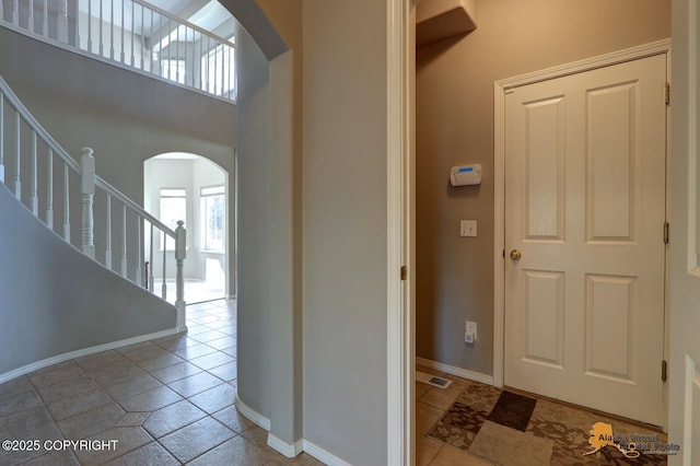 16059 Hidden Creek Ln, Anchorage, AK 99516 - foyer featuring arched walkways, stairs, and baseboards
