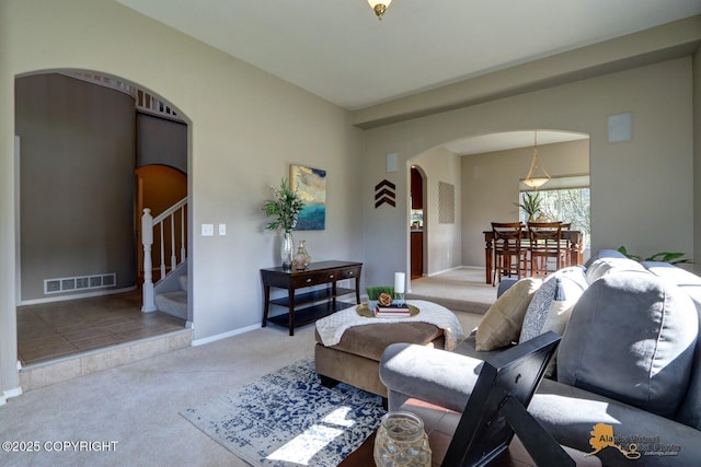 16059 Hidden Creek Ln, Anchorage, AK 99516 - carpeted living area with arched walkways, stairway, and baseboards