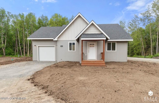1338 N Unicorn Cir, Palmer, AK 99645 - view of front facade featuring an attached garage, roof with shingles, driveway, and board and batten siding