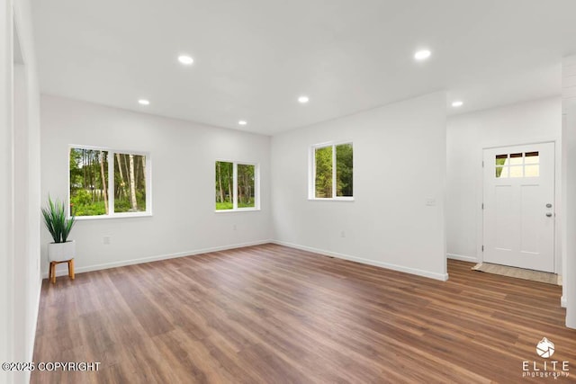 1338 N Unicorn Cir, Palmer, AK 99645 - unfurnished room with healthy amount of natural light, recessed lighting, wood finished floors, and baseboards