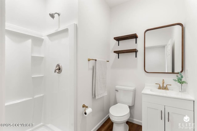 1338 N Unicorn Cir, Palmer, AK 99645 - full bathroom with vanity, a shower, wood finished floors, toilet, and baseboards