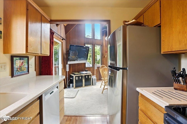142 Vail Cir, Girdwood, AK 99587 - kitchen with dishwasher, light countertops, brown cabinets, and a sink