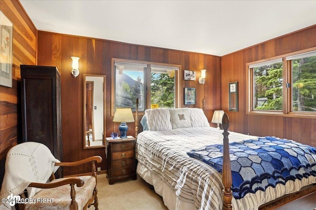 142 Vail Cir, Girdwood, AK 99587 - bedroom with multiple windows, wood walls, and light carpet